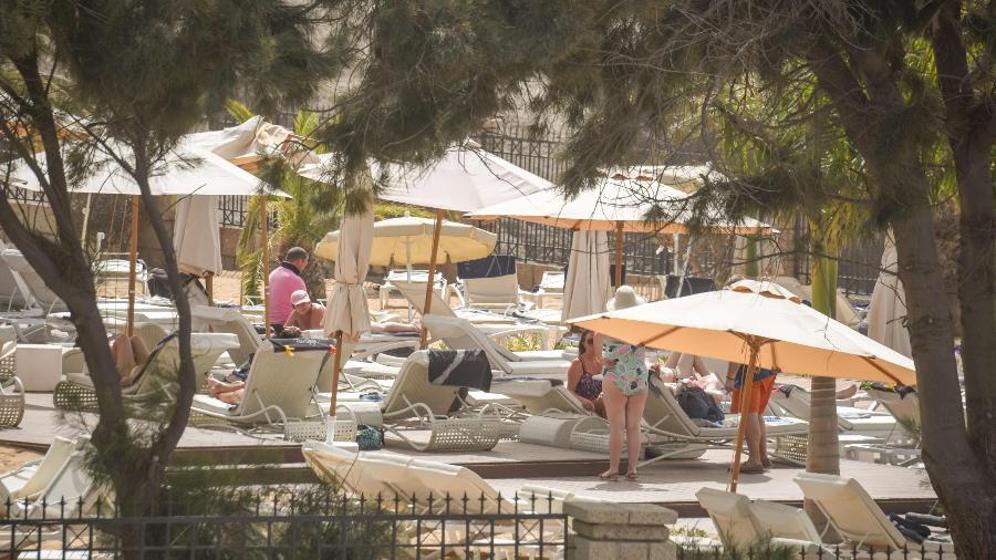 Os turistas no Hotel H10 Costa Adeje Palace em La Caleta, em 25 de fevereiro de 2020, onde centenas de pessoas foram confinadas depois que um turista italiano foi hospitalizado com um caso suspeito de coronavírus - Desiree Martin / AFP