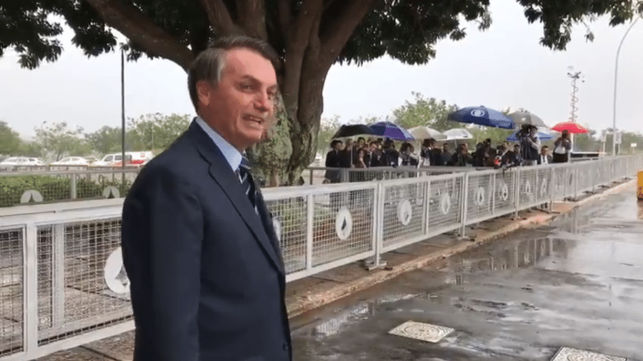 Bolsonaro deixando o Palácio da Alvorada; ao fundo, jornalistas que cobrem a Presidência. - Reprodução/Twitter