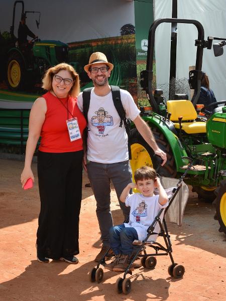 Família com criança visitando a Agrishow Família com criança visitando a Agrishow