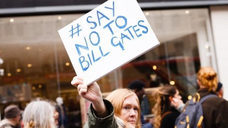 An activist in London holds up a sign that reads 'Say no to Bill Gates' - Nurphoto - Nurphoto
