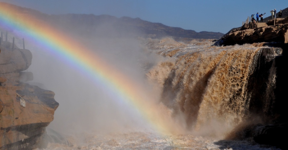 27.out.2015 - Turistas fotografam arco-íris na cachoeira Hukou, na Província de Shanxi, na China