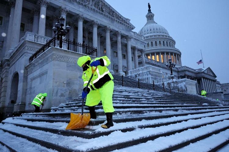 Equipes trabalham antes do amanhecer para limpar a neve dos degraus do Capitólio antes da cerimônia para certificar vitória de Trump