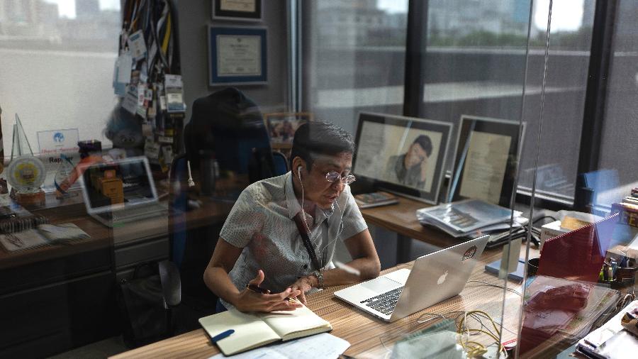 Maria Ressa, fundadora da Rappler, em sua mesa em Manila, nas Filipinas - Jes Aznar/The New York Times