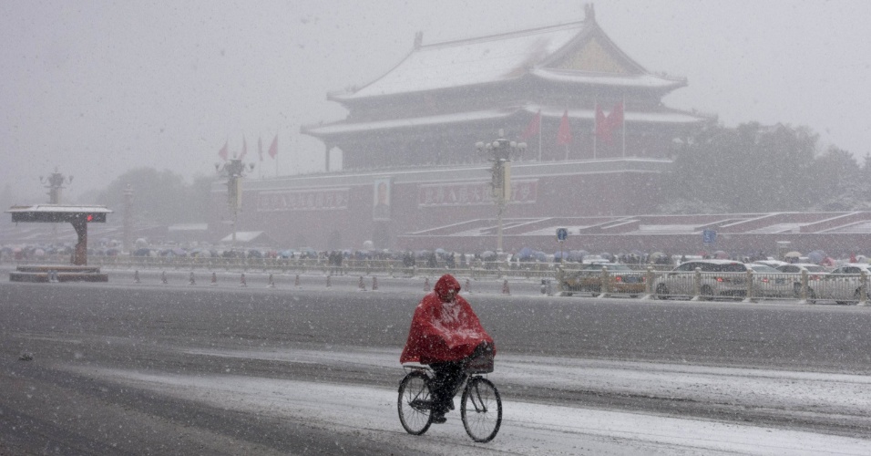 23.nov.2015 - Ciclista passa por avenida de Tiananmen em meio a uma forte nevasca em Pequim, na China