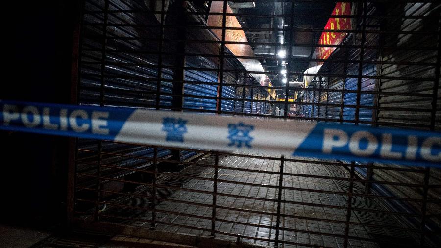 Equipe sanitária de Wuhan realiza buscas em mercado de frutos do mar onde um homem que morreu por problemas respiratório fez compras - NOEL CELIS/AFP