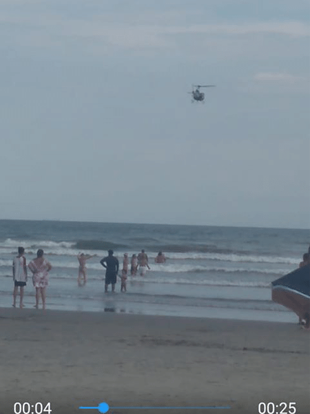 07.jan.2020 - Imagem registrada por banhista durante tentativa dos Bombeiros de socorrer um jovem em Praia Grande, no litoral de São Paulo - Reprodução