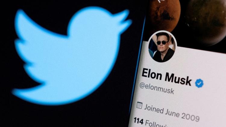 Elon Musk's Twitter account shown on a cellphone is shown next to the social network logo - Dado Ruvic/Reuters - Dado Ruvic/Reuters
