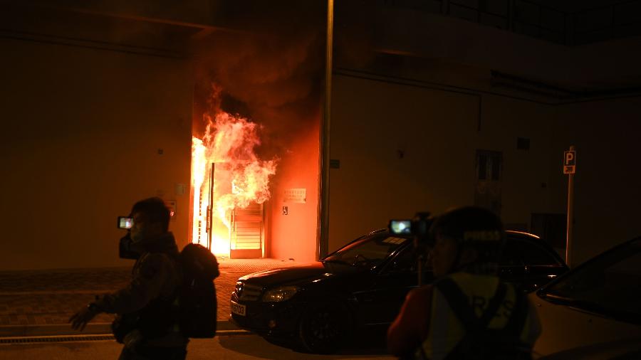 A entrada de conjunto habitacional é incendiada durante protestos contra os planos da propriedade ser usada como campo de quarentena - Philip Fong/AFP