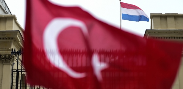 12.mar.2017 - Bandeira da Turquia é agitada diante do consulado da Holanda em Istambul - Yasin Akgul/ AFP