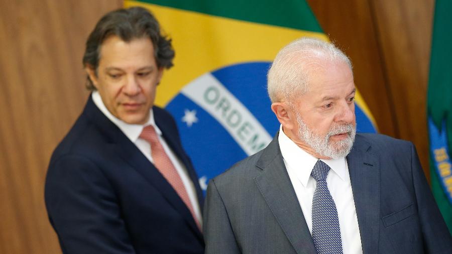 26.mar.2024 - O ministro da Fazenda, Fernando Haddad, e o presidente Lula durante assinatura de atos do programa Mover
