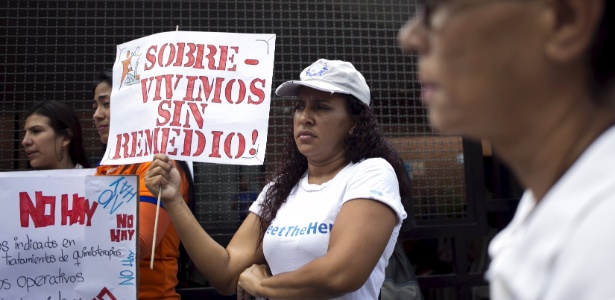 Mulher segura cartaz que critica a falta de medicamentos na Venezuela - REUTERS