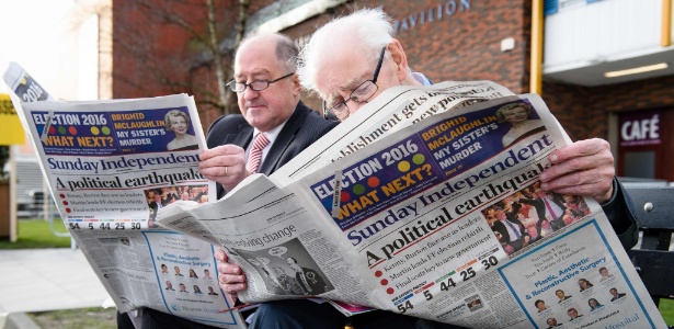 Membros do Fianna Fail leem jornais com noticiário sobre as eleições em Dublin (Irlanda) - Leon Neal/AFP