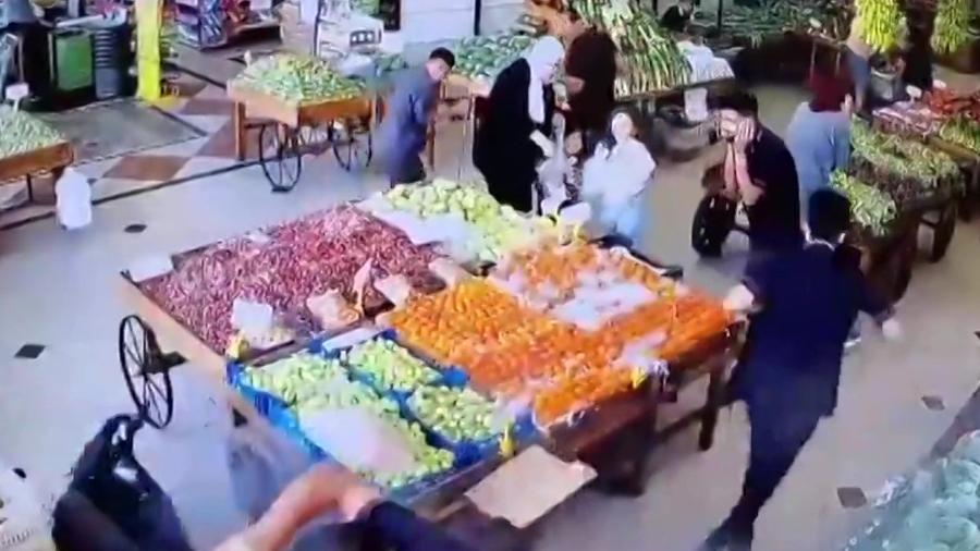 17.set.2024 - Vídeo postado nas redes sociais mostra uma explosão e um homem caindo no chão enquanto outros se abrigam em um mercado em Beirute - ANONYMOUS / AFP