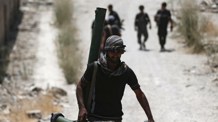 27.jul.2015 - Soldado do Exército Livre da Síria carrega armas enquanto caminha para a sua posição - Bassam Khabieh/Reuters