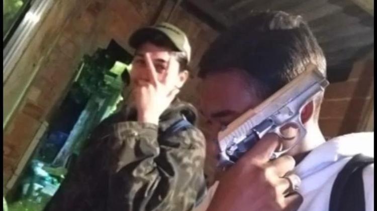 Kauã Jason Jason da Silva segura arma que teria sido usada no crime, segunda a polícia