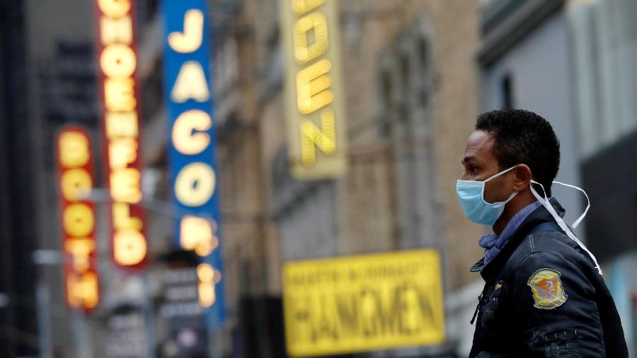 Homem usando máscara caminha pela Broadway após anúncio de cancelamentos por causa do coronavírus - Andrew Kelly/Reuters