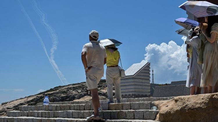 Tourists on Pingtan island, China's closest region to Taiwan, see a trail of smoke from missiles - Hector Retamal/AFP - Hector Retamal/AFP