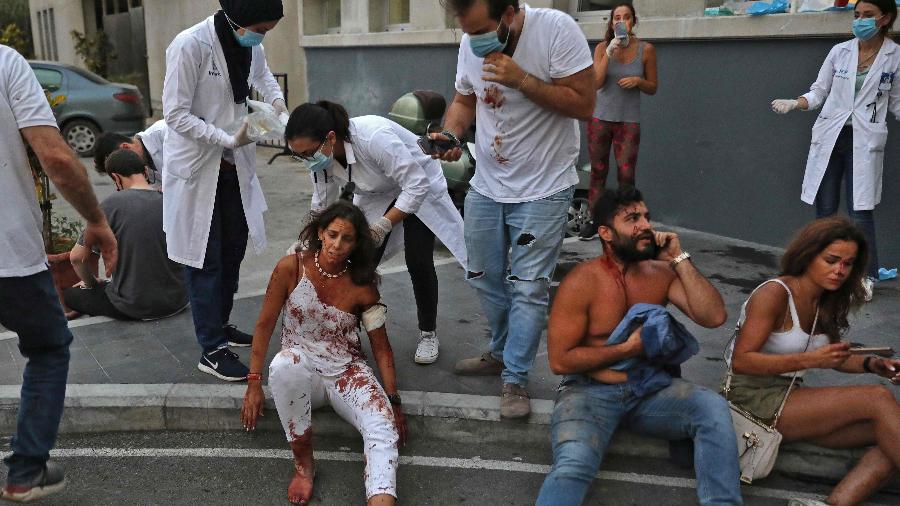 Feridos após explosão em Beirute aguardam atendimento em frente a hospital na capital do Líbano - IBRAHIM AMRO/AFP