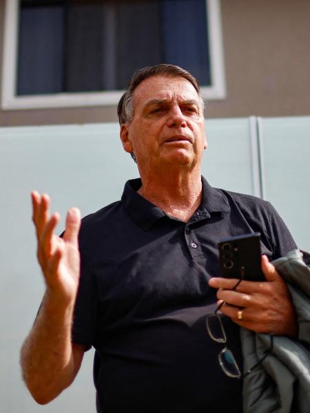 O ex-presidente Jair Bolsonaro gesticula em frente à sua casa antes de prestar depoimento à PF