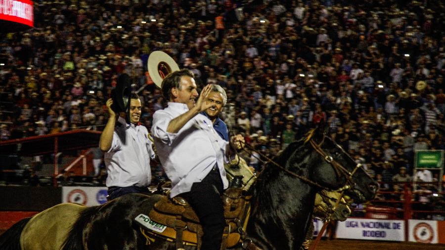 Jair Bolsonaro e o governador de Goiás, Ronaldo Caiado (DEM), andam a cavalo na festa do peão de Barretos - Ricardo Benichio/Folhapress