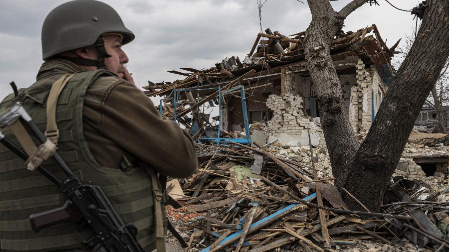 26.mar.2022 - Soldado em frente de casa destruda em Krasylivka, na periferia de Kiev, na Ucrnia - Marko Djurica/Reuters