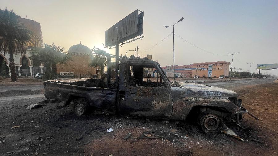 Veículo queimado em Cartum, no Sudão, em meio a confrontos entre milícias e o Exército do país - EL TAYEB SIDDIG/REUTERS