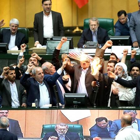 9.mai.2018 - Deputados iranianos queimam uma bandeira dos EUA de papel e uma cópia do acordo sobre o programa nuclear na tribuna do Parlamento, aos gritos de "morte aos Estados Unidos", um dia depois de Washington abandonar o pacto 9.mai.2018 - Deputados iranianos queimam uma bandeira dos EUA de papel e uma cópia do acordo sobre o programa nuclear na tribuna do Parlamento, aos gritos de "morte aos Estados Unidos", um dia depois de Washington abandonar o pacto