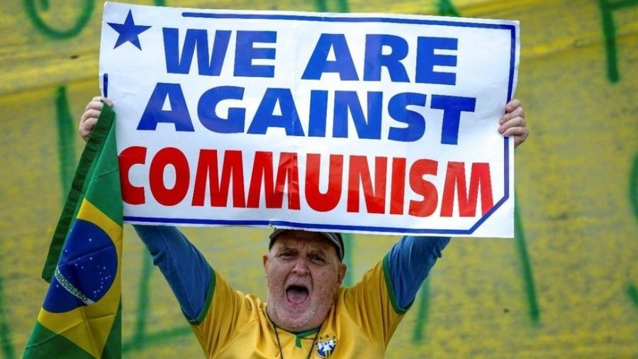 Manifestante segura cartaz com frase em inglês "nós somos contra o comunismo" em São José dos Campos (SP) - Roosevelt Cassio/Reuters