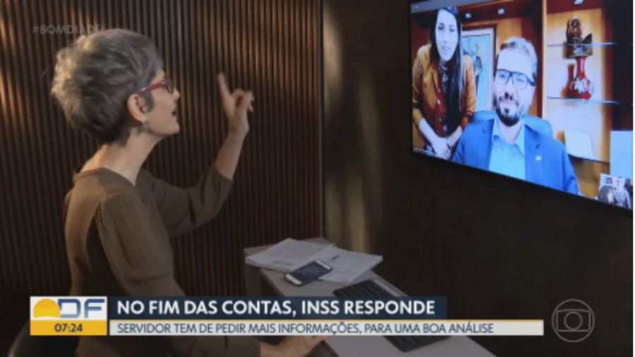Assessora interrompe entrevista com presidente do INSS - Reprodução/TV Globo