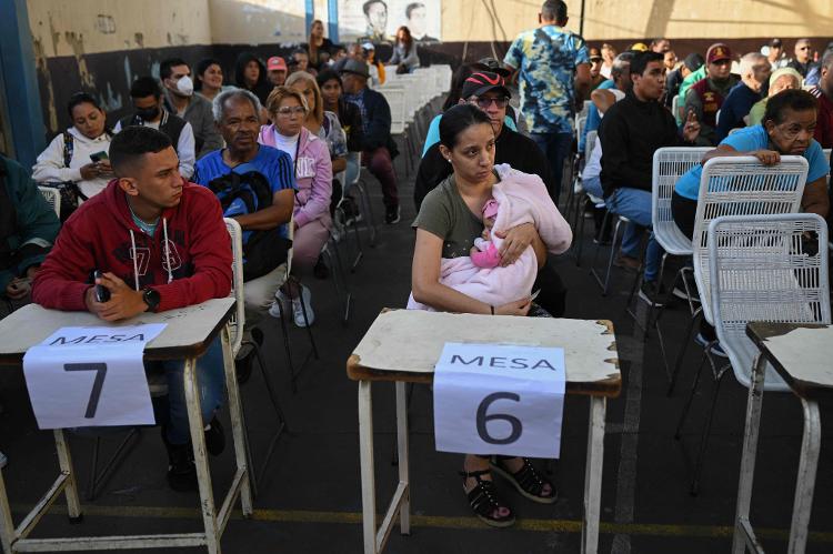 Pessoas esperam sua vez para votar em uma seção eleitoral em Caracas, durante a eleição presidencial venezuelana