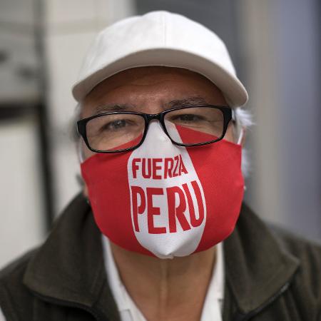 Homem usa máscara com os dizeres "Força, Peru" durante crise do coronavírus - Stringer/Getty Images