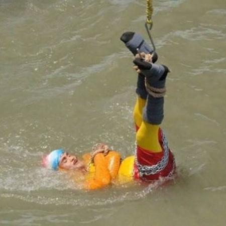 Chanchal Lahiri entrou na água com braços e pernas amarrados por cordas e com uma corrente de metal pelo corpo - Ei Samay/BBC