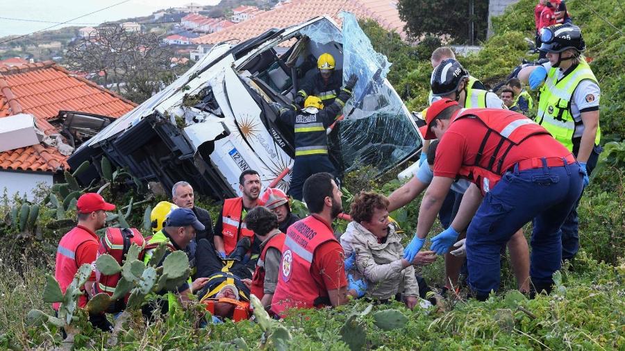 Bombeiros ajudam vítimas de acidente com ônibus de turismo na ilha da Madeira, em Portugal - RUI SILVA / AFP