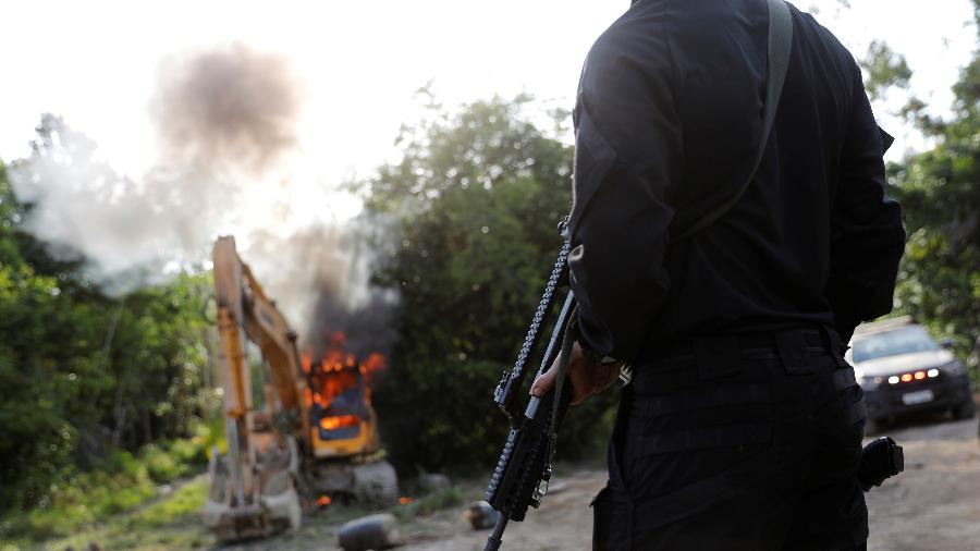 30.ago.2019 - Agente da PF olha para máquinas destruídas durante operação conduzida em conjunto com o Ibama em uma mina de ouro ilegal perto de Altamira, no Pará - Nacho Doce/Reuters