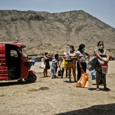 Peruanos aguardando para receber alimentos em Comas, ao norte de Lima - AFP