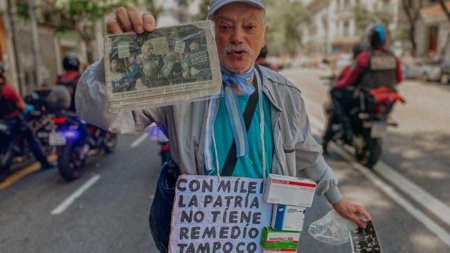 O aposentado Miguel Messine, 75, mostra foto sua publicada em jornal em 2001, ano de crise na Argentina, e diz que o país vai viver algo igual com Milei