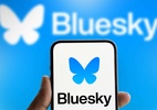 Como silenciar uma conta no Bluesky [iPhone e web] - Bluesky em um telefone com marca ao fundo