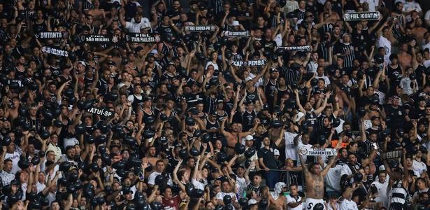 Torcida do Corinthians enfrenta chuva intensa para apoiar equipe no clássico.