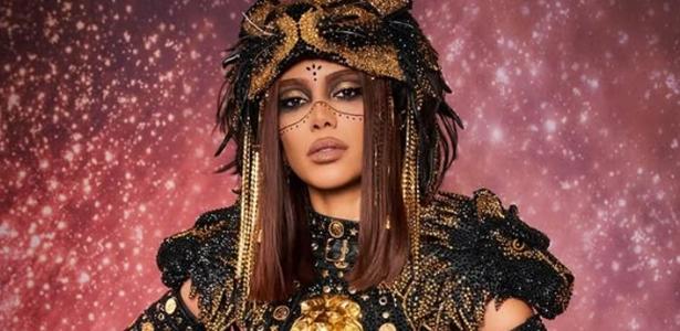Anitta performing on a brightly lit stage during the FIFA World Cup 2026 opening ceremony, with fireworks in the background.