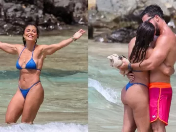 Juliana Paes dá beijão no marido e curte últimas horas do ano na praia 