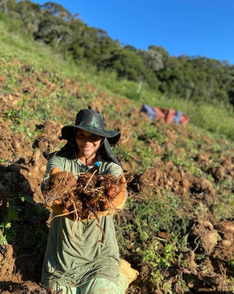 Ariani Lacerda segura inhames que colheu em plantação da família no interior de Marechal Floriano (ES)